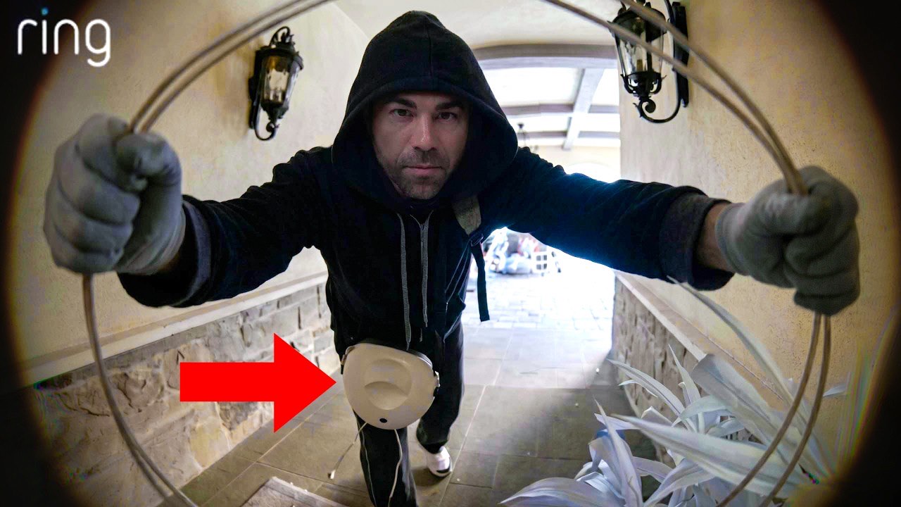 Mark Rober's "I Outsmarted Pro Car Thieves" thumbnail, a Ring-camera fisheye point of view of a hooded figure reaching toward the lens, with a red arrow pointing at a device